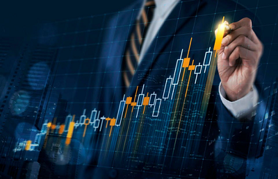 Man in suit and tie, from chest down, drawing on chart
