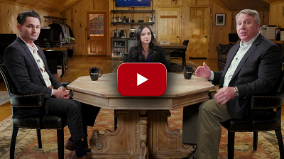 Two men, lady, sitting at table - play video icon